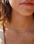Model wearing 925 sterling silver Spiral Necklace. This necklace features the simple chain with the spiral eternity disc.