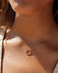 Model wearing 14k gold fill spiral Necklace. This necklace features the simple chain with the spiral eternity disc.