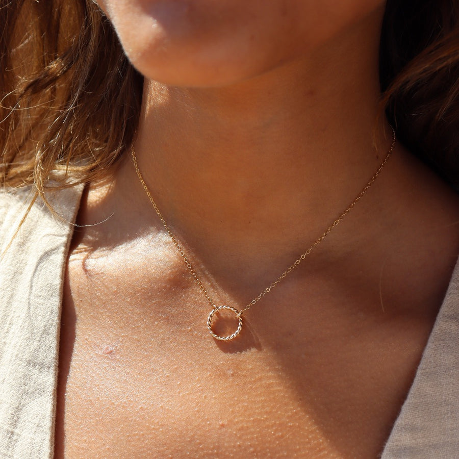 Model wearing 14k gold fill spiral Necklace. This necklace features the simple chain with the spiral eternity disc.