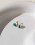 small stud 14k gold fill earrings with malachite stone photographed on a ceramic dish | handmade by Token Jewelry in Eau Claire Wisconsin