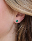 small stud 14k gold fill earrings with malachite stone photographed on a blonde model | handmade by Token Jewelry in Eau Claire Wisconsin