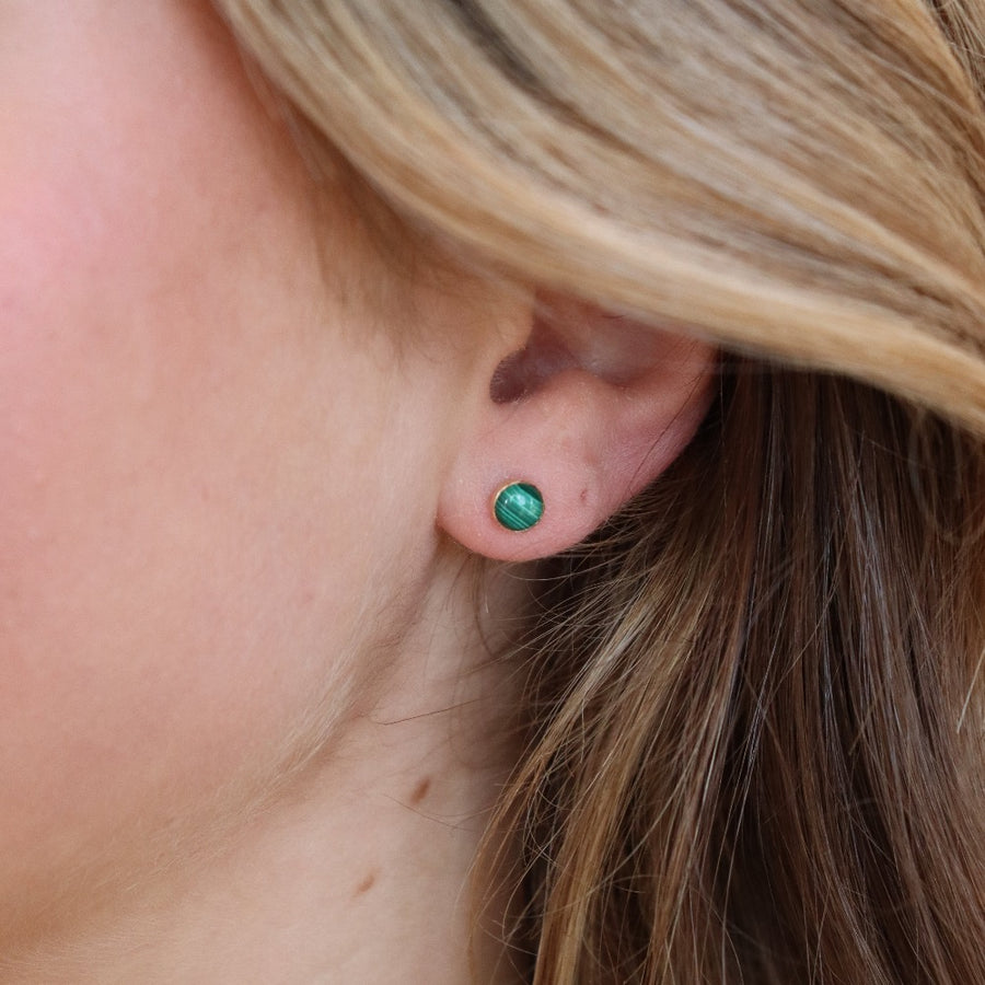 small stud 14k gold fill earrings with malachite stone photographed on a blonde model | handmade by Token Jewelry in Eau Claire Wisconsin