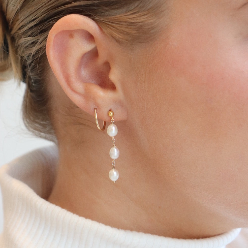 Model wearing 14k gold fill Trillium Pearl Drops - Token Jewelry. Sterling Silver or 14k Gold Fill. Token Jewelry, handmade, hypoallergenic and waterproof.