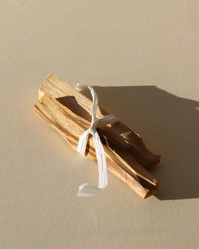 palo Santo sticks lying on a sunlit tabletop