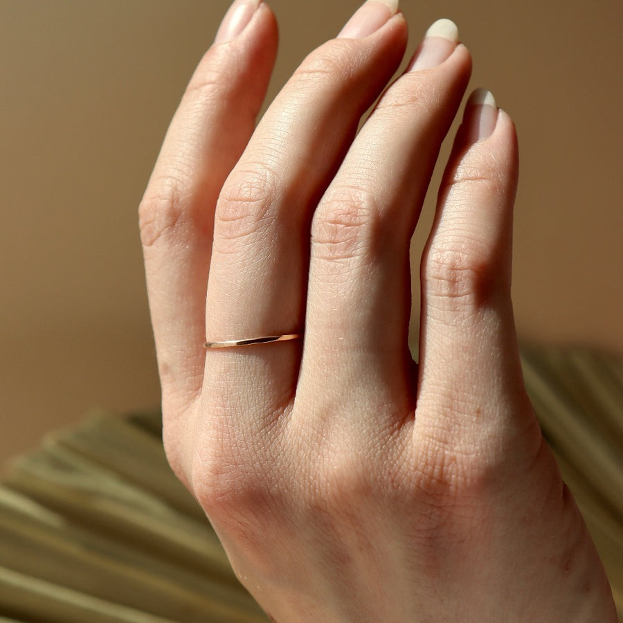 dainty hammered gold stacking ring on model handcrafted by Token Jewelry in Eau Claire, Wisconsin