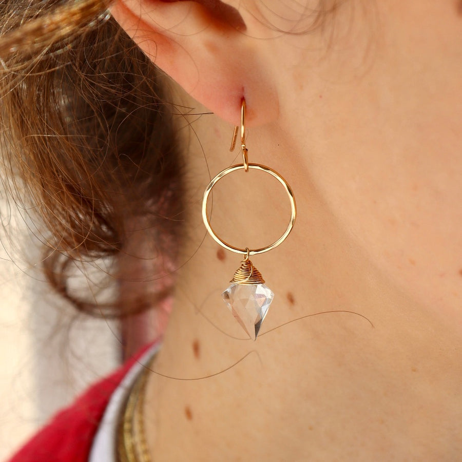 gorgeous gold hoops with crystal quartz accent on model handmade by Token Jewelry in Eau Claire Wisconsin