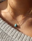 turquoise gemstone necklace pictured on a model