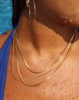 Model wearing g14k gold fill classic herringbone chain