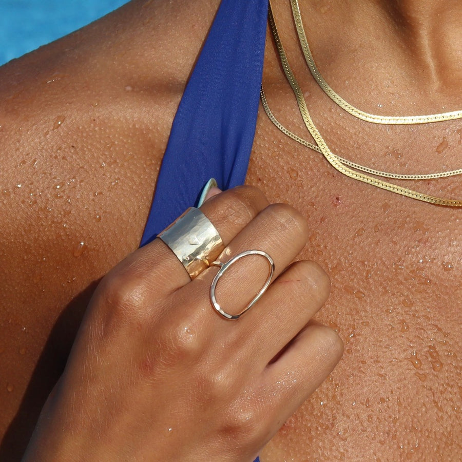 14k gold filled olivia ring paired with the cuff ring on a model swimming.
