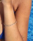 14k gold filled alexandra bracelet on a model in the water.