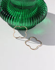 14k gold fill 4-leaf clover shaped slide earrings, photographed next to a green vase