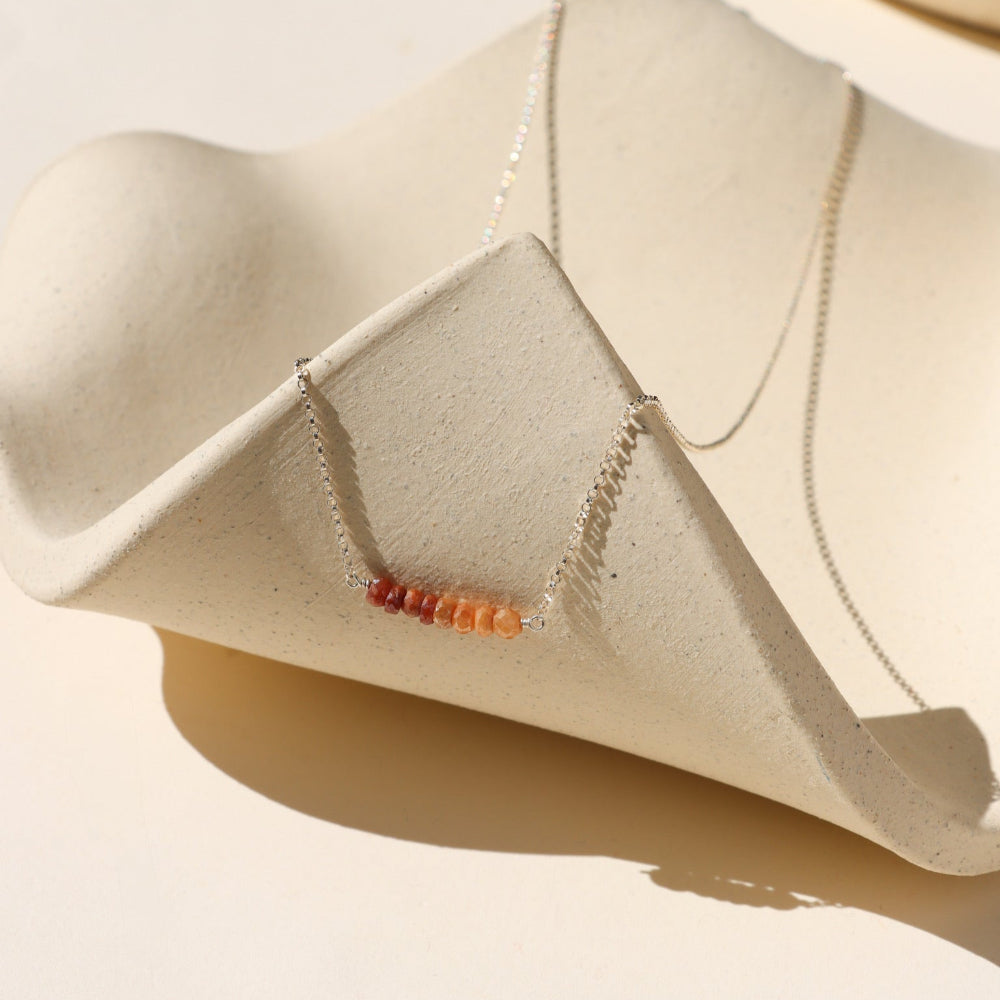 sterling silver chain necklace with topaz beads wrapped in the center