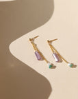 14k gold fill stud earrings with chain, purple zircon tubes, pearls, and moss agate on a light background