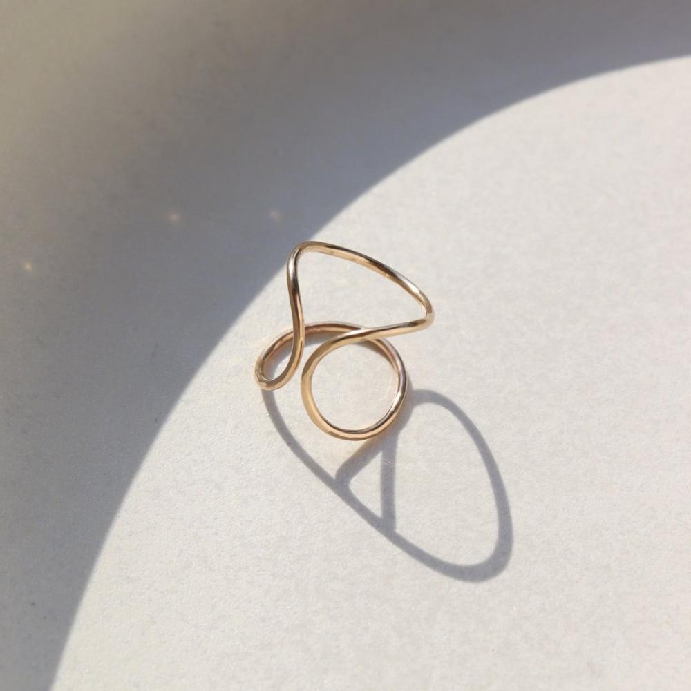 Isla Ring laid on a white plate in the sunlight.