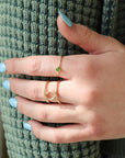 Model wearing 4mm Jade Gemstone Ring set in a 14k gold fill bezel with simple hammered ring band.