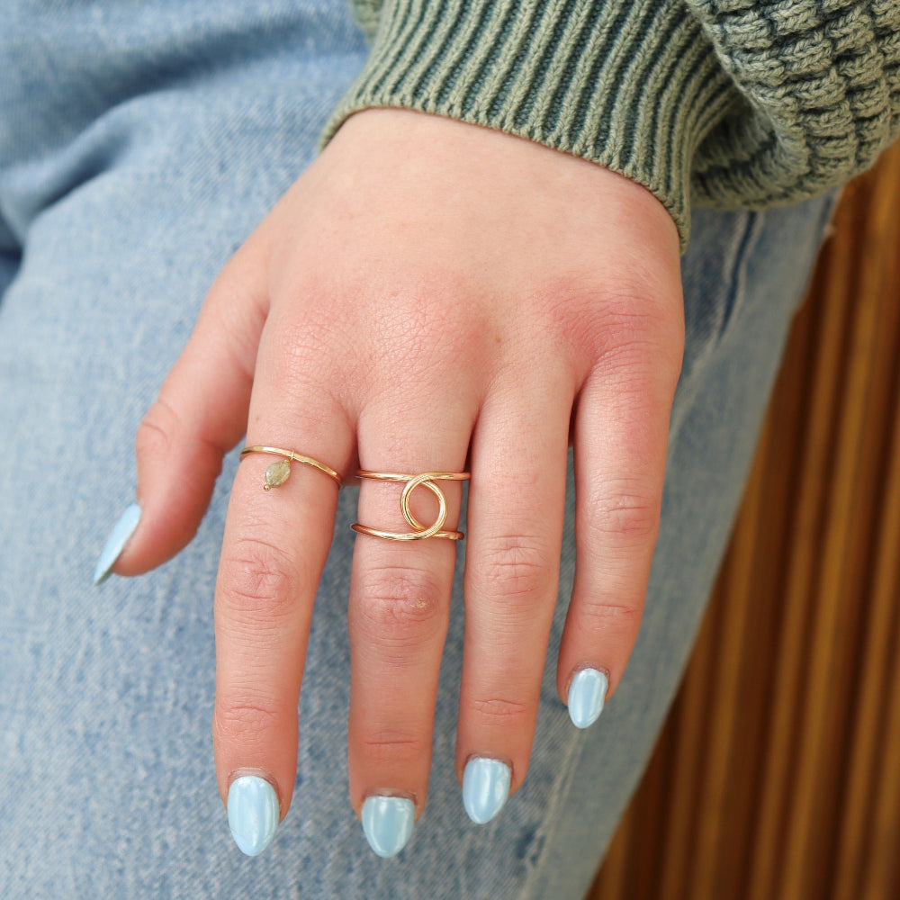 Model wearing a 14k gold fill hammered band with a kyanite gemstones freely hanging from the band. 