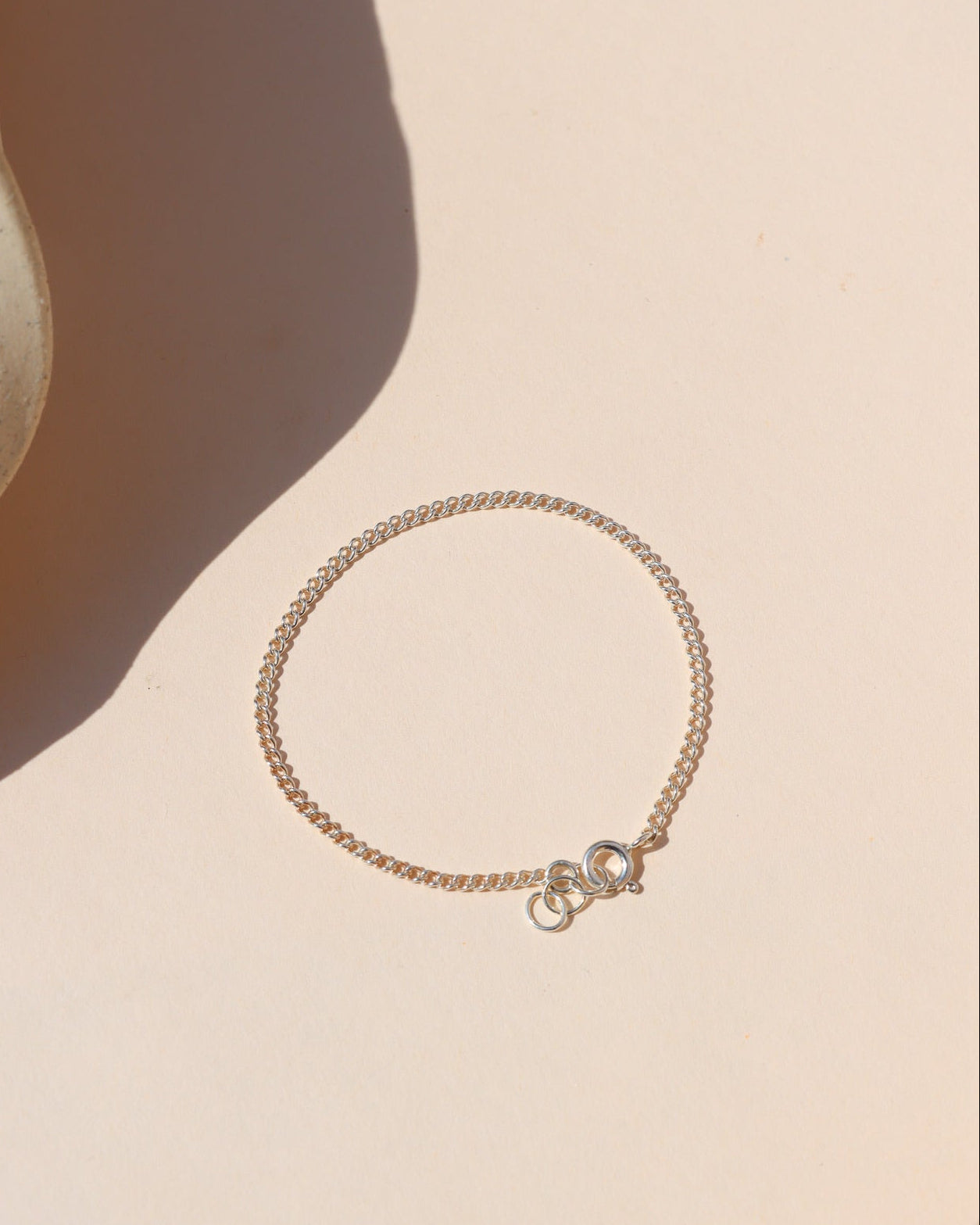sterling silver delicate curb chain bracelet in the sunlight