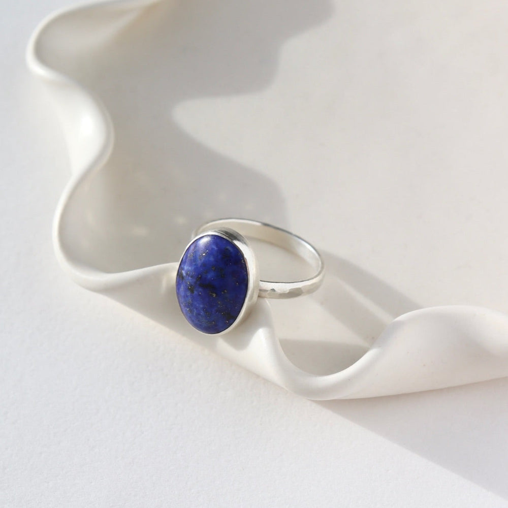 Lapis Lazuli Gemstone Ring in sterling silver. This ring features a thick silver hammered band with a 12x16mm Lapis gemstone. 