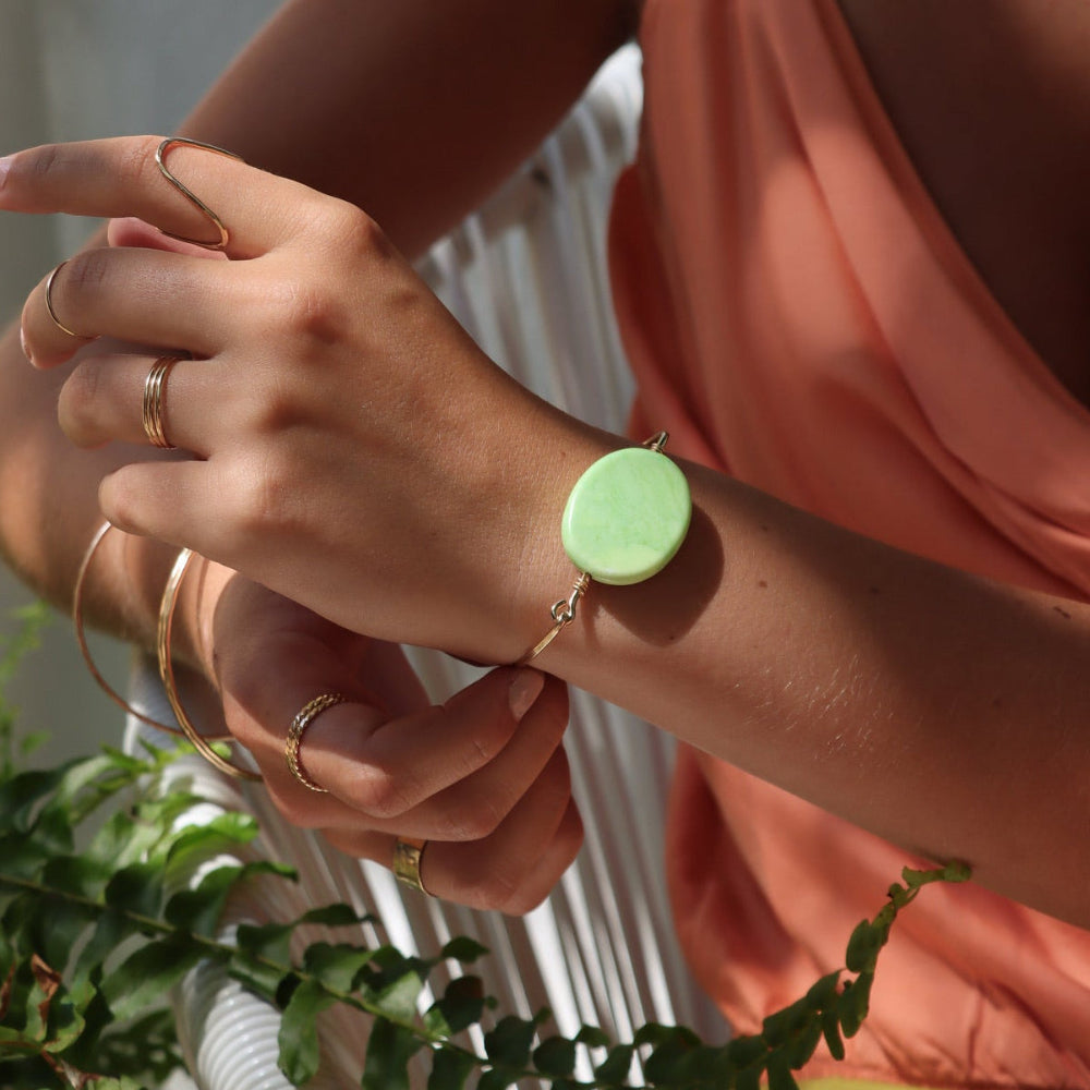 model wearing 14k gold fill wire bracelet with oval chrysoprase stone 