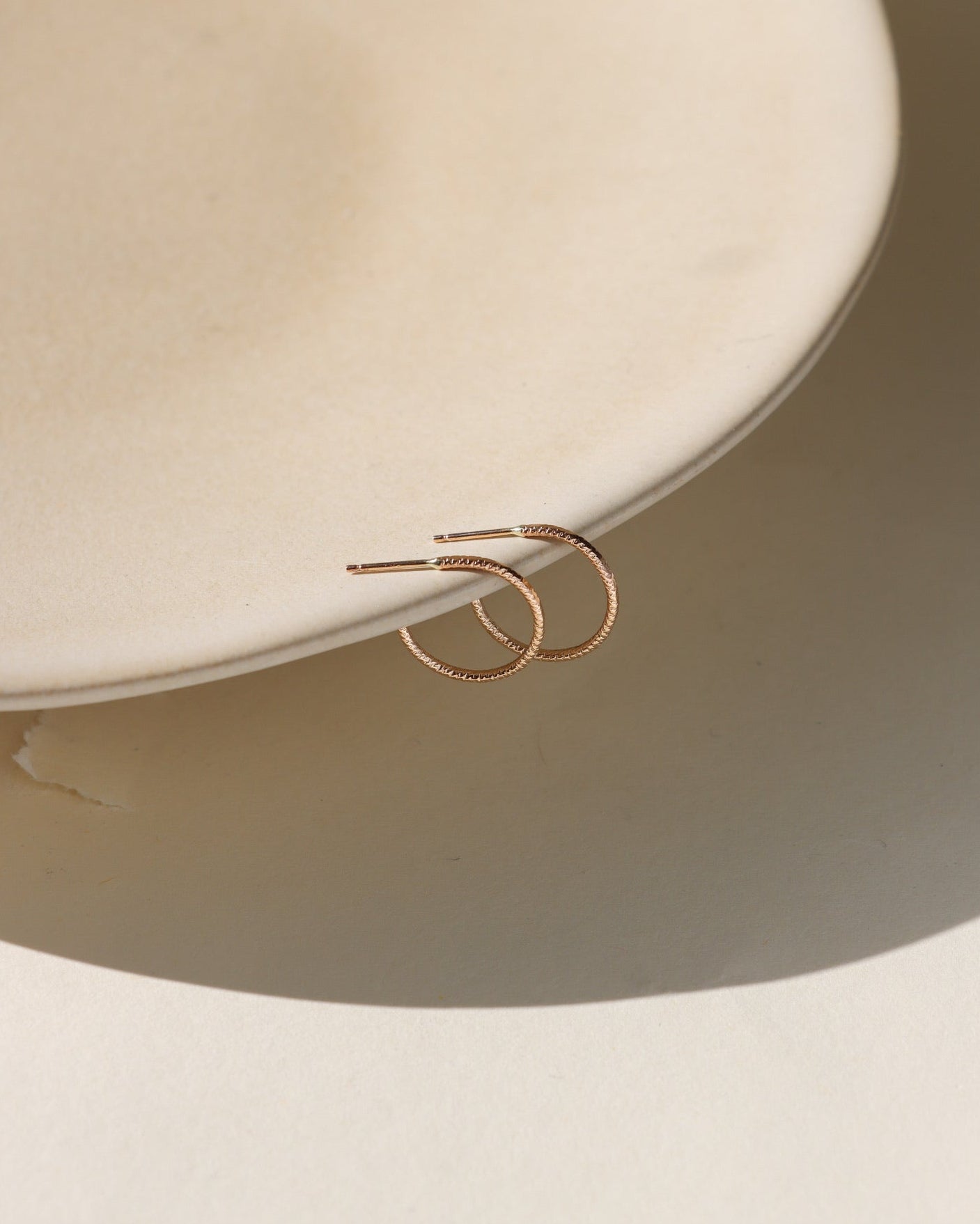 Lumen Hoops — 14K gold fill or sterling silver hoops with a sparkling wire. Lightweight, modern, and perfect for layering or wearing solo