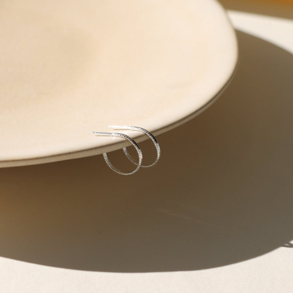 Lumen Hoops — 14K gold fill or sterling silver hoops with a sparkling wire. Lightweight, modern, and perfect for layering or wearing solo