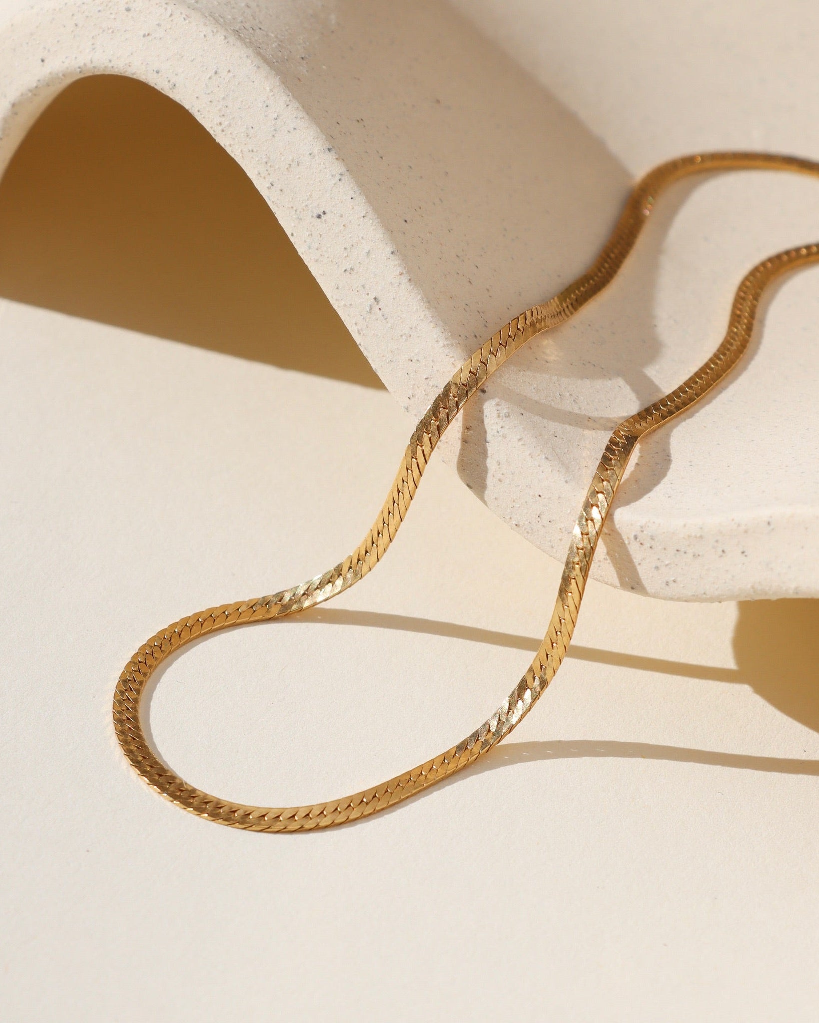 14k gold fill chain in the sunlight on a dish