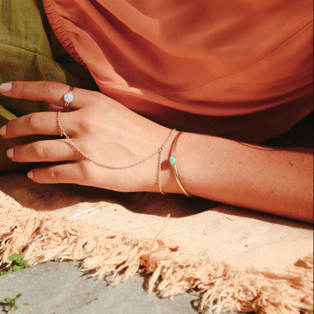 model wearing 14k gold fill cuff with oval amazonite stone paired with other 14k gold fill jewelry