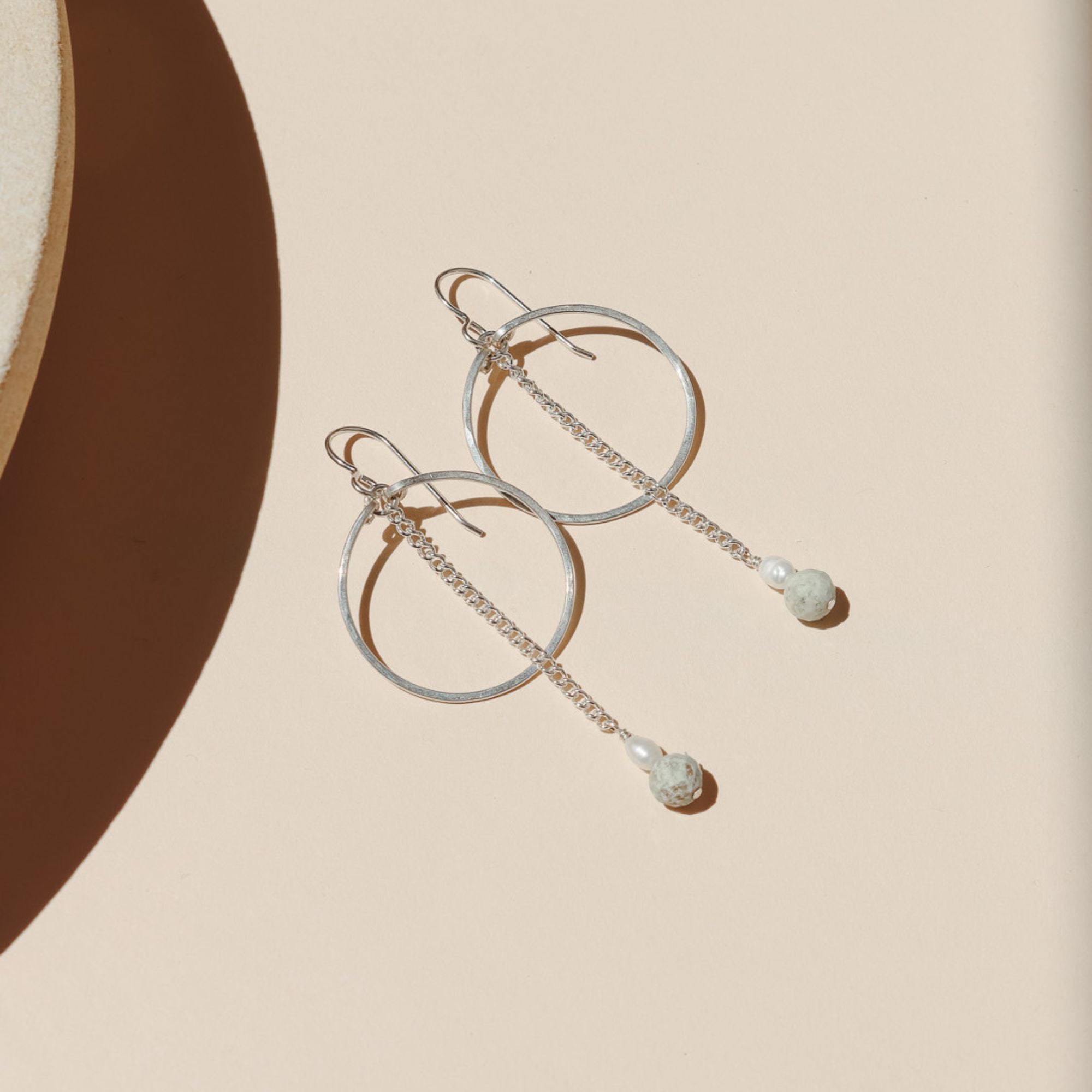 14k gold fill hoops with chain, pearl, and turquoise beads in the sunlight