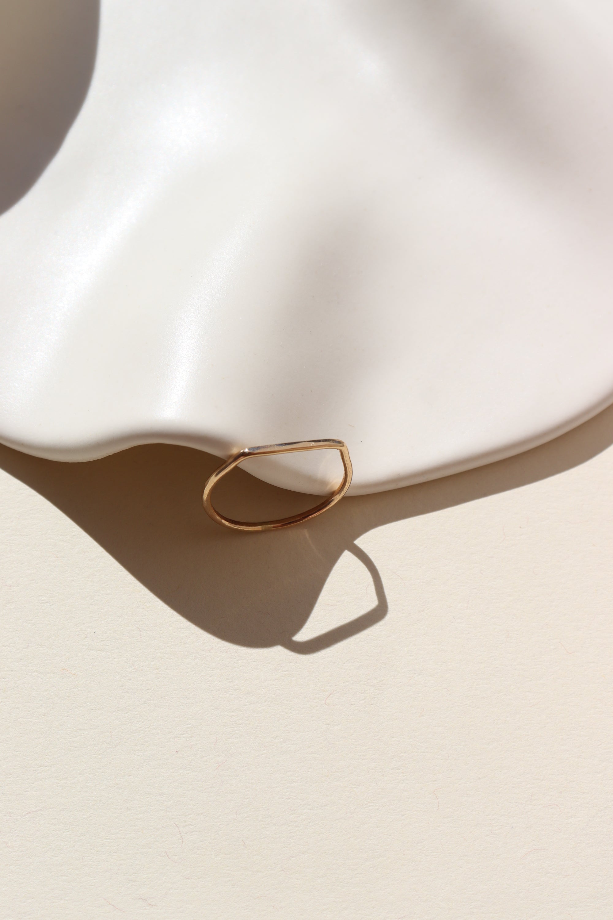 Mesa ring laid on a tan plate in the sunlight.