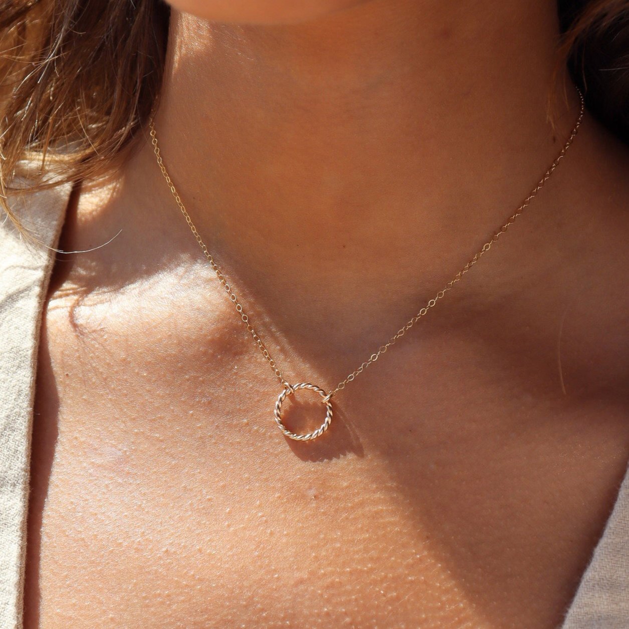 Model wearing 14k gold fill spiral Necklace. This necklace features the simple chain with the spiral eternity disc.