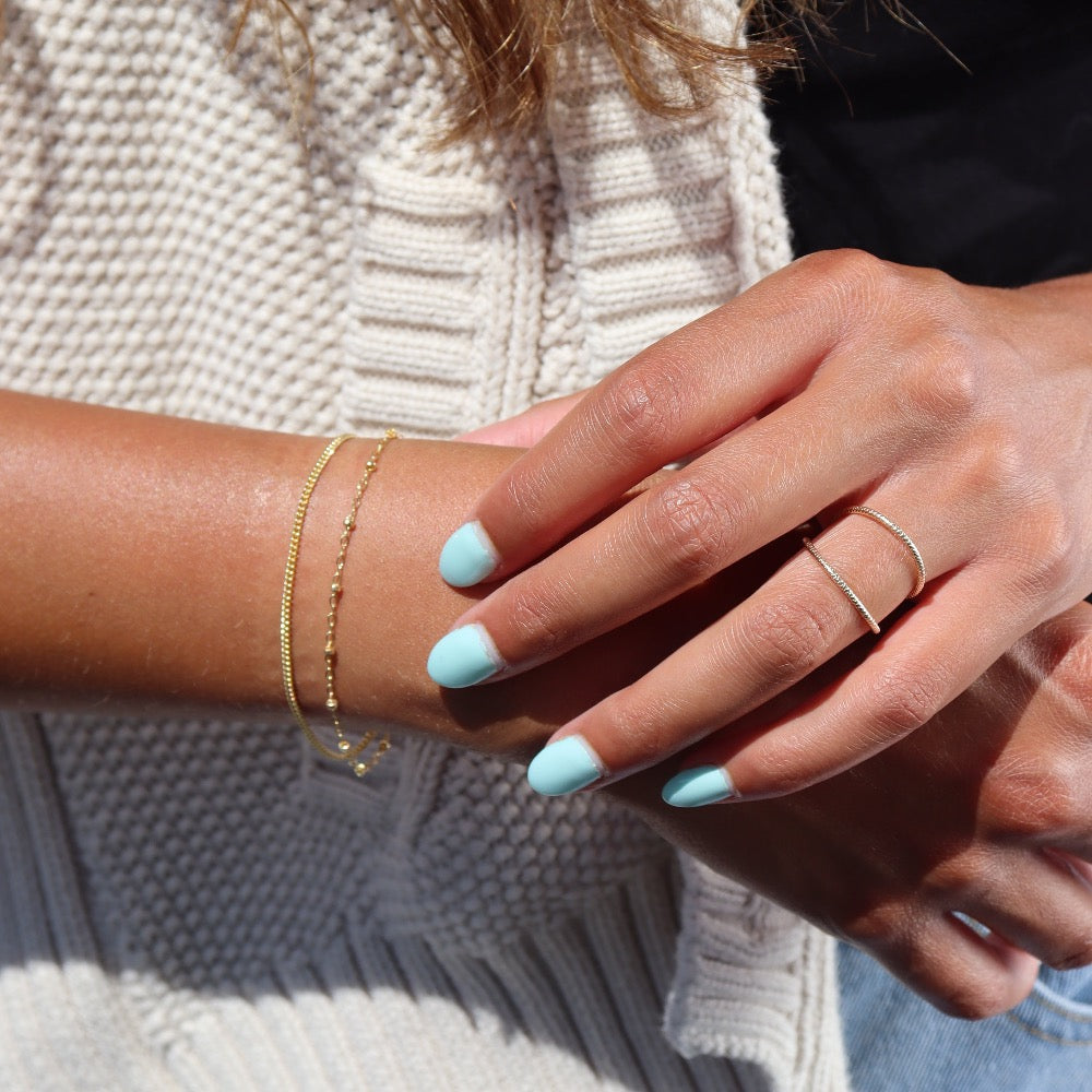 Model wearing 14k gold fill Harmony bracelet .