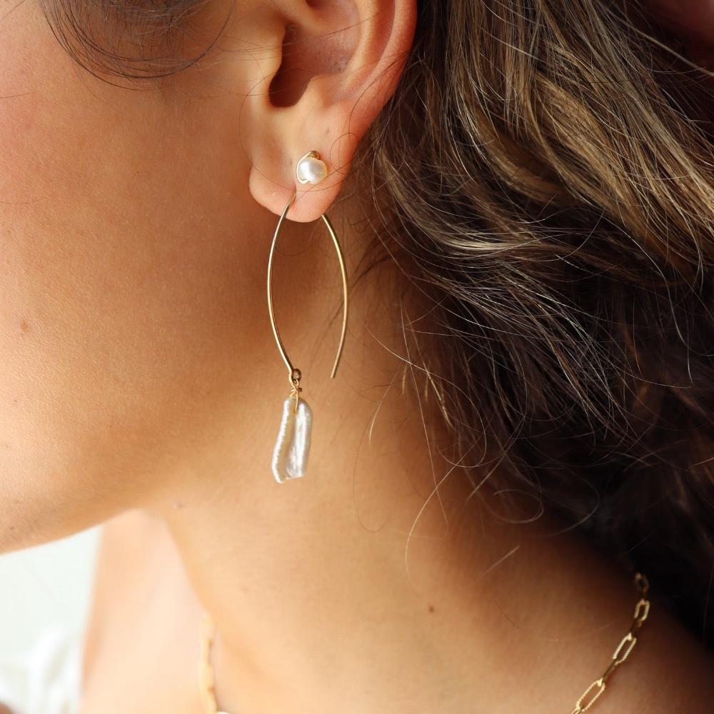 Model Wearing 14k gold fill Juno earrings pair with the pearl studs