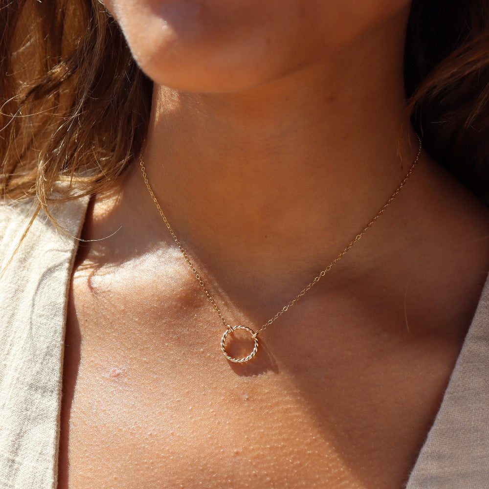 Model wearing 14k gold fill spiral Necklace. This necklace features the simple chain with the spiral eternity disc.