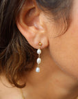 Model wearing Trillium Pearl Drop Earrings