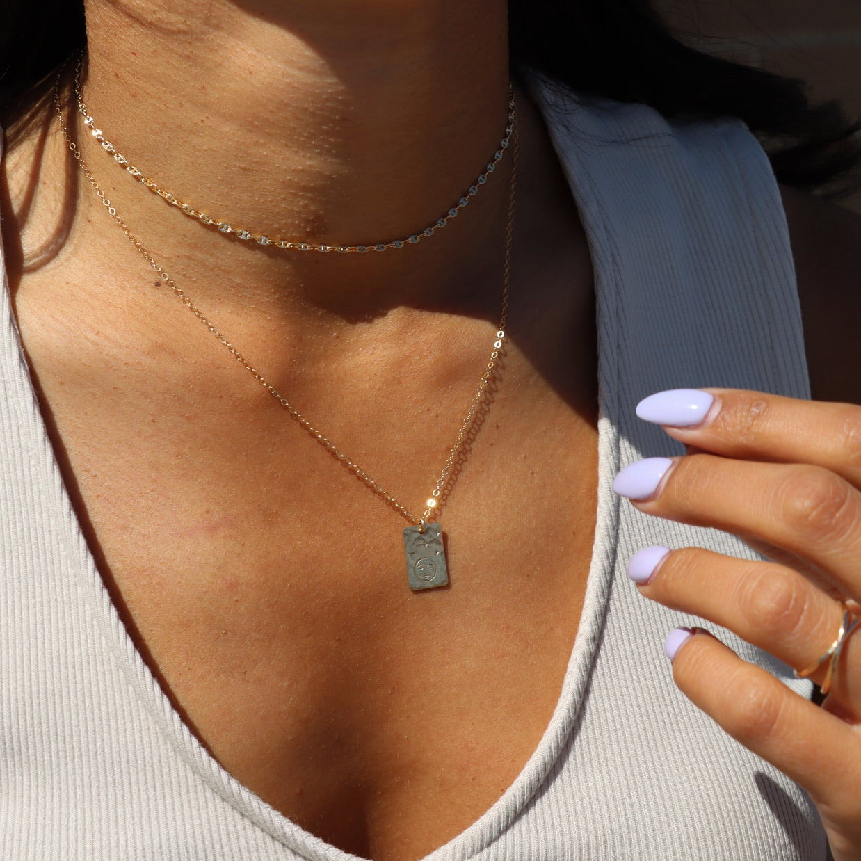 model wearing 14k gold fill chain necklace with hand stamped moon and star pendant 