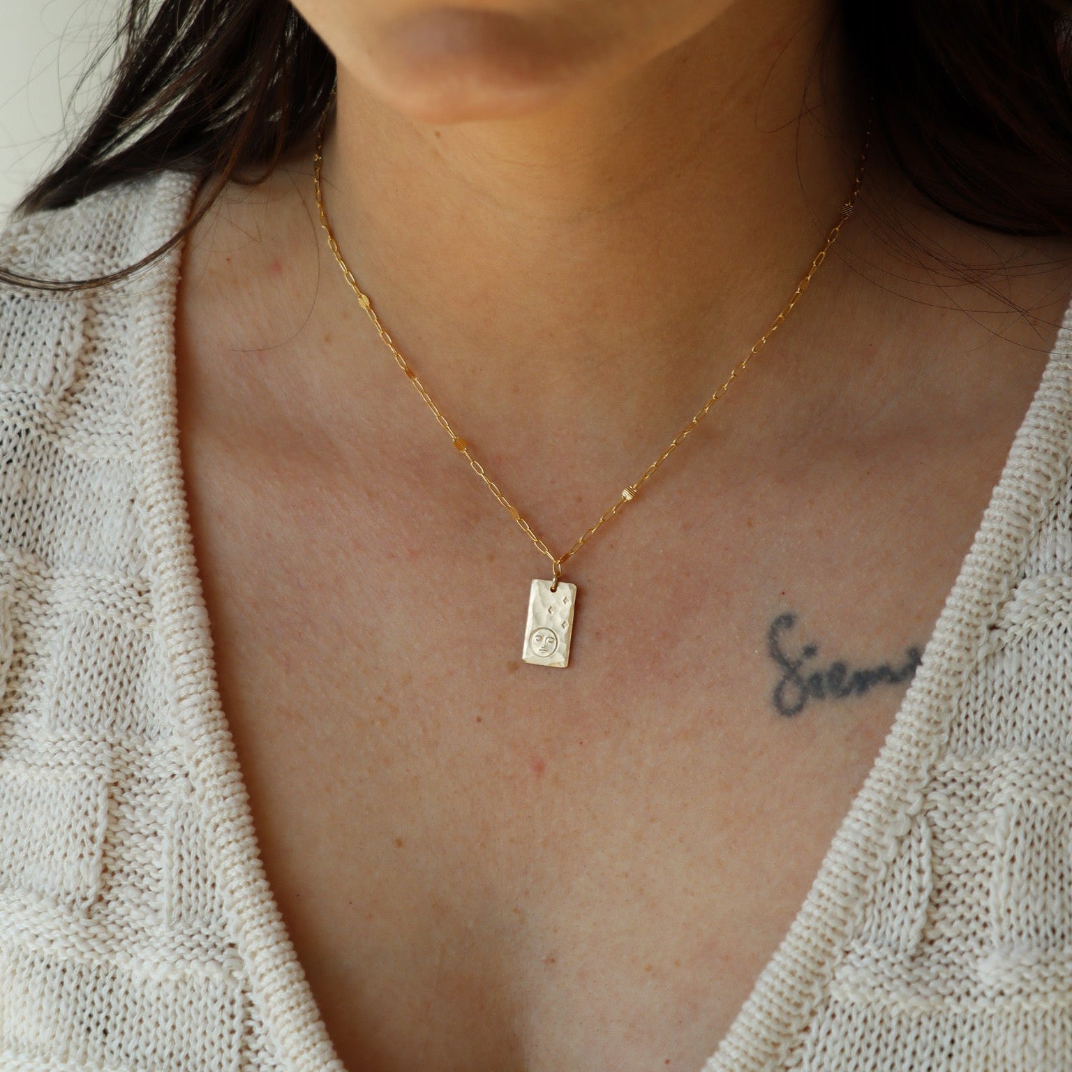 model wearing 14k gold fill delicate chain necklace with hand stamped pendant with moon and stars