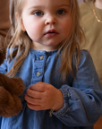 14k gold fill heart link chain in children's sizes, photographed on a little girl wearing a blue denim dress and holding a teddy bear