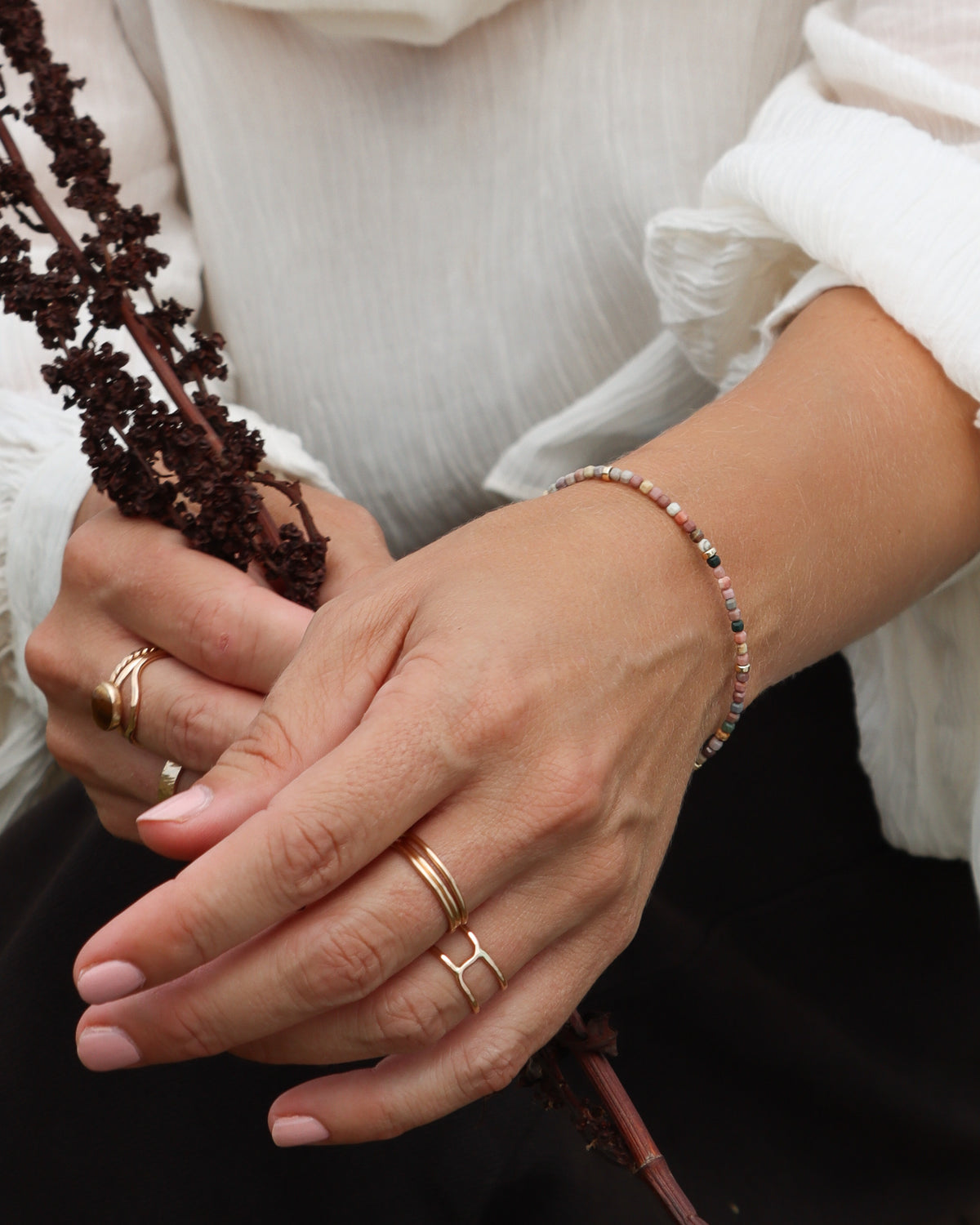 Gold-filled geometric open band ring styled with stacked rings and a multicolor beaded bracelet.