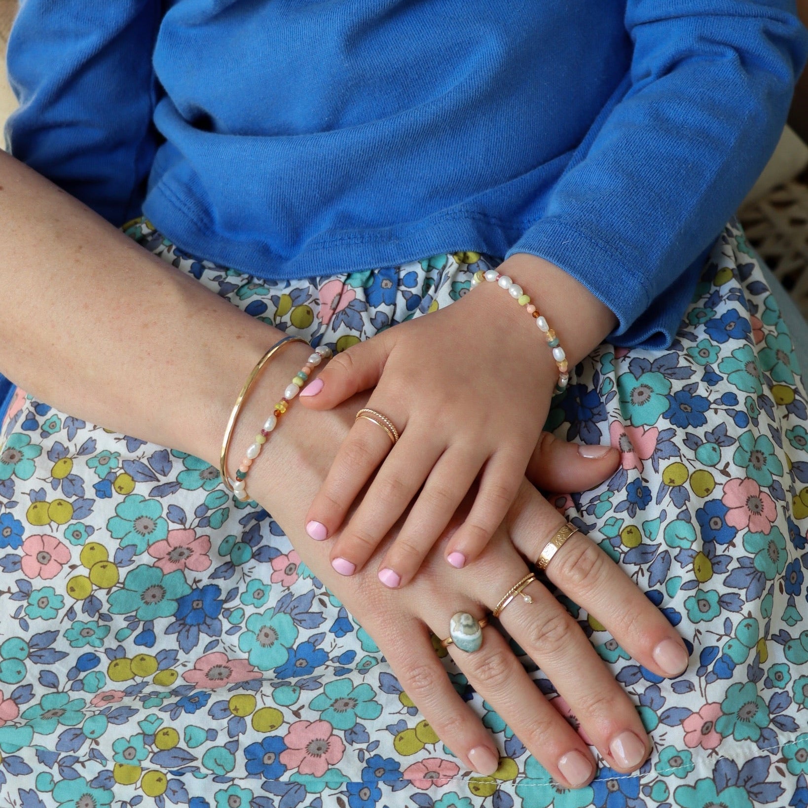 models wearing hand beaded bracelet with Pearl, Coral, Opal, Hessenite, Grandidenite, Tourmaline, Moonstone