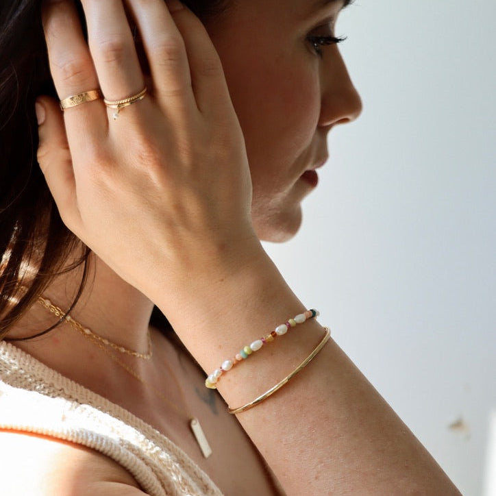 model wearing 14k gold fill jewelry with beaded bracelet
