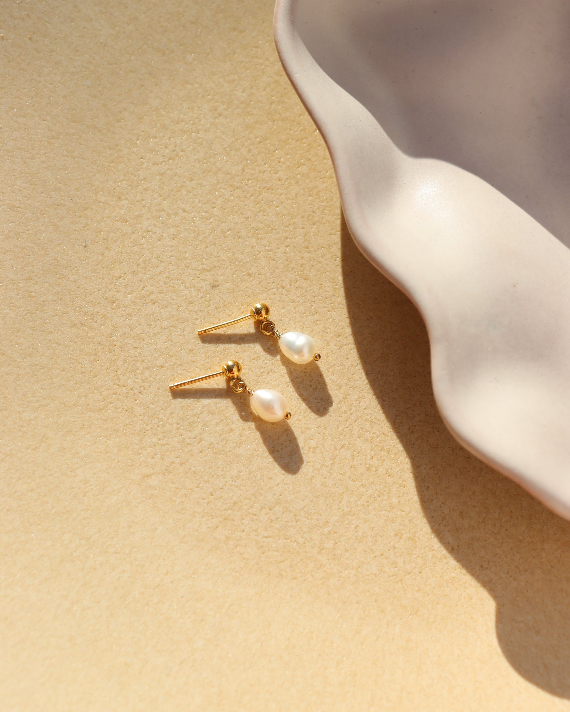 delicate handmade pearl drop stud earrings. made by Token Jewelry in Eau Claire, wisconsin