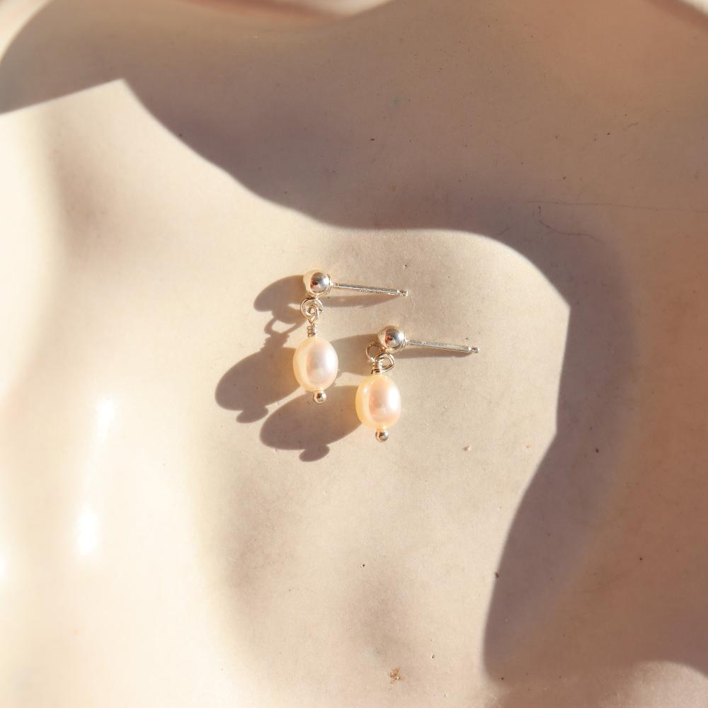 delicate handmade pearl drop stud earrings. made by Token Jewelry in Eau Claire, wisconsin