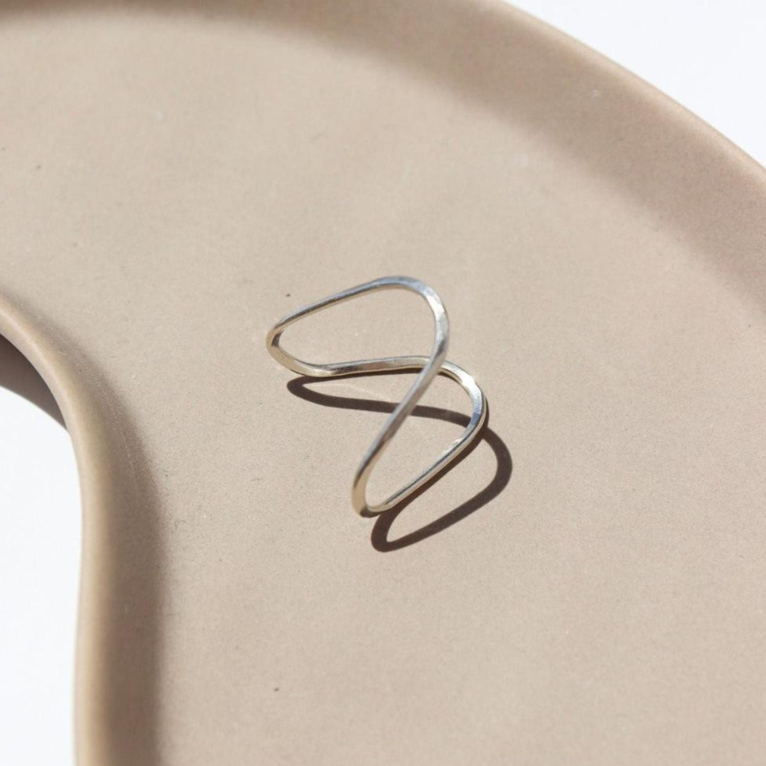 Close up of hand-crafted sterling silver rising tide ring.