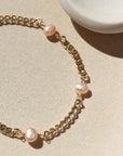 Rosalie Bracelet in 14k gold fill on a an plate in the sunlight