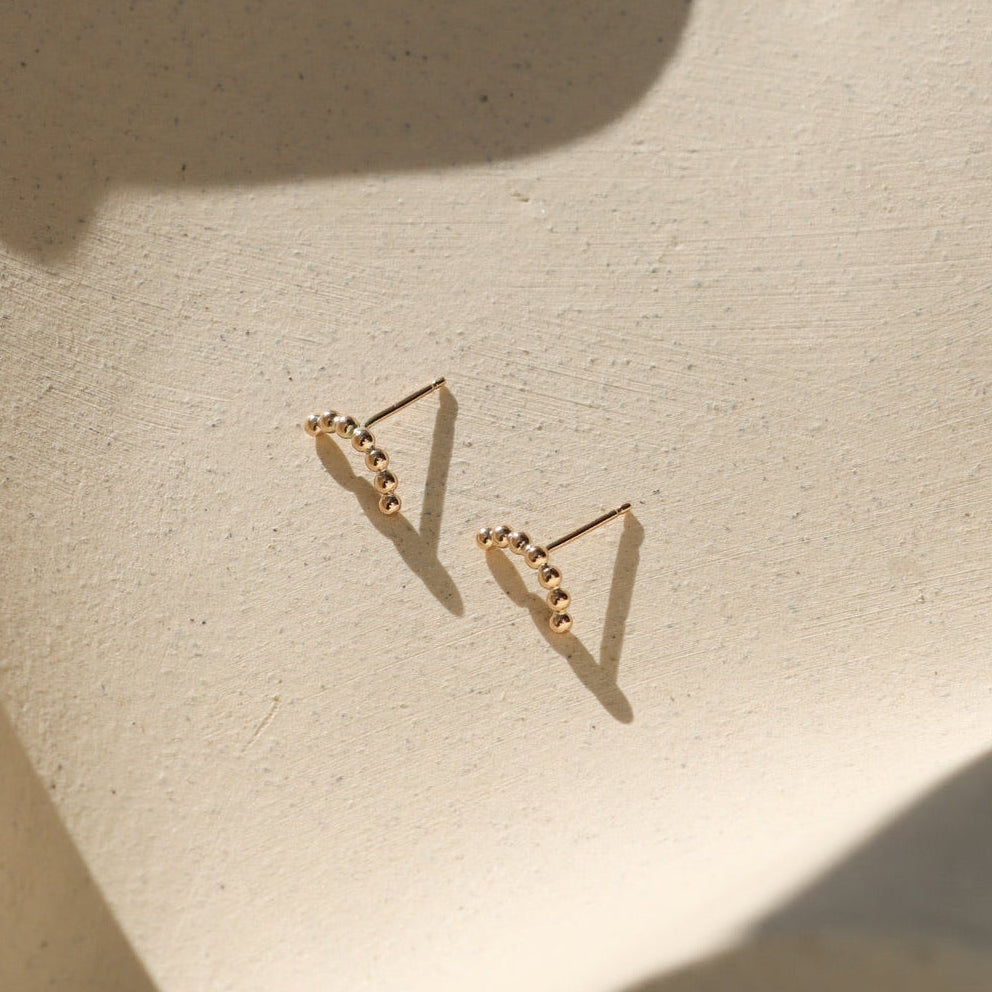 14k gold fill sequin wire stud earrings on a light background