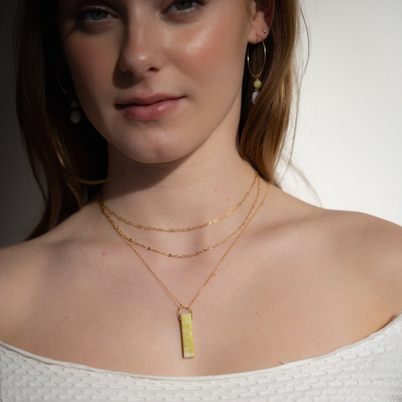 model wearing 14k gold fill chain necklaces paired with 14k gold fill delicate chain necklace with serpentine pendant