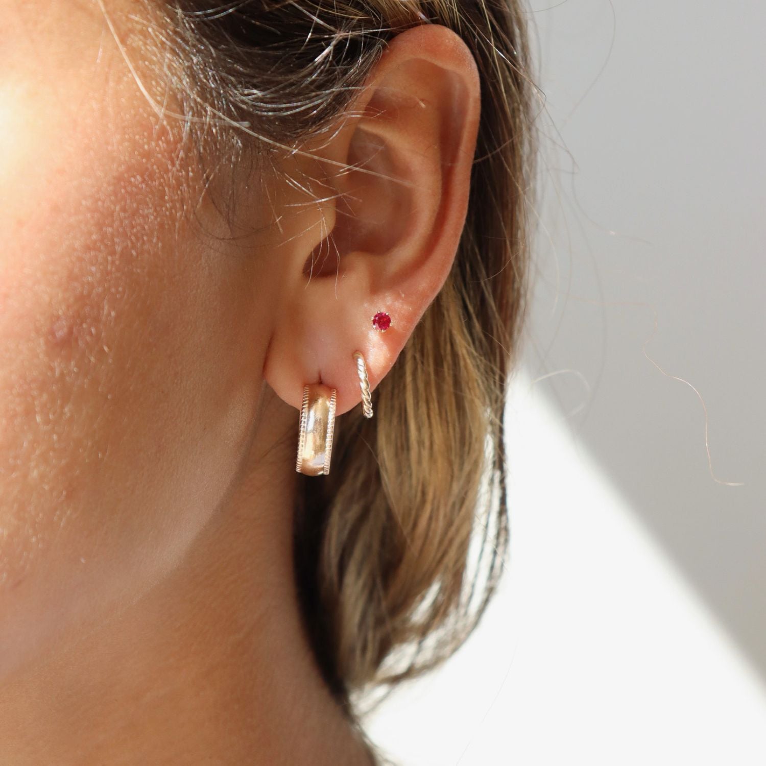 model wearing 14k gold fill hoops with gemstone stud