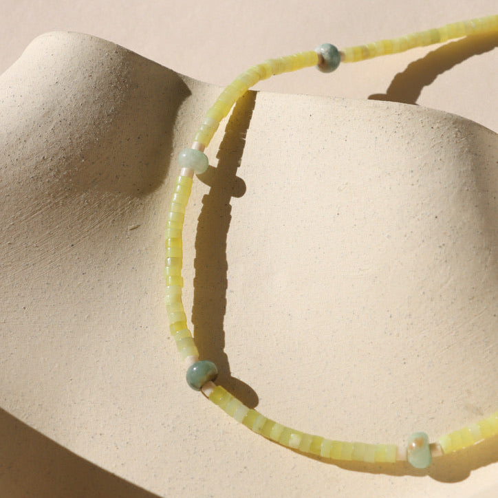 jade and jasper beaded necklace with 14k gold fill fixings on a light background