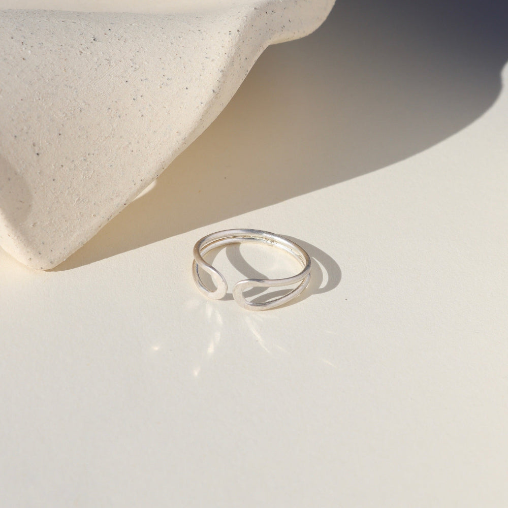sterling silver sculptural ring on a light background