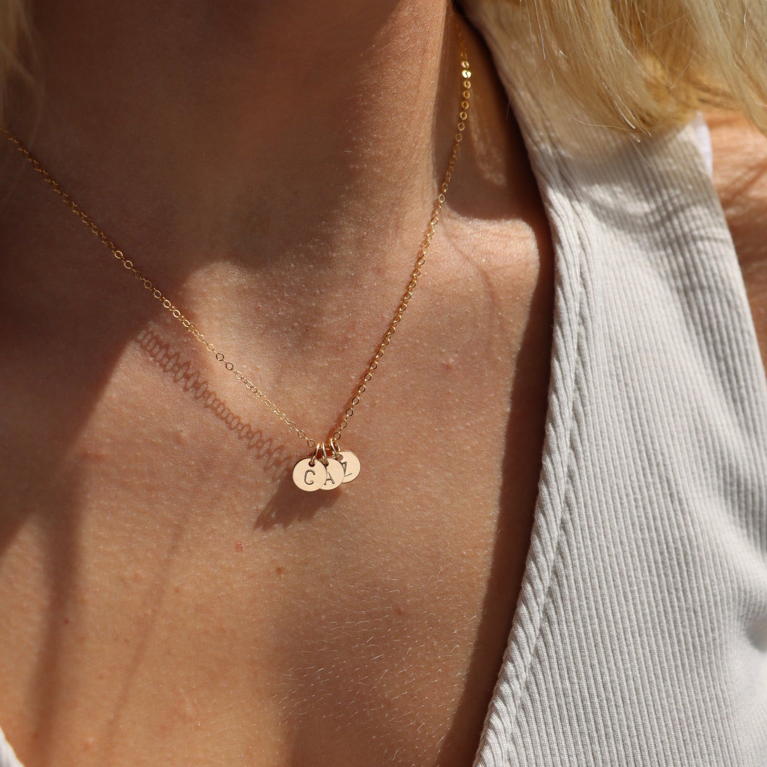 model wearing 14k gold fill delicate chain necklace with three stamped discs